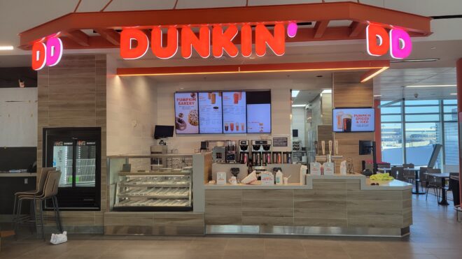Dunkin’ sign: Dunkin’ Donuts sign with orange and pink lettering.
