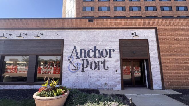 Custom exterior wall signage for restaurant featuring dimensional lettering on a painted brick facade