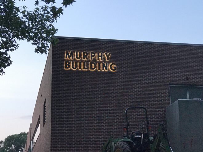 Exterior brick building with lit Fabricated Metal letters "Murphy Building"