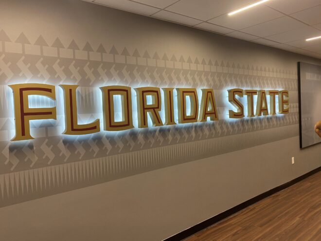 Large-scale illuminated wall signage for Florida State University showcasing custom lettering and backlighting for high-impact institutional branding